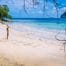 Is Palawan Safe For Tourists To Travel? | Tikigo Tips (Photo of a beach in El Nido with the text HELP drawn in sand)